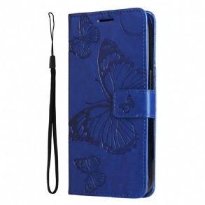 Bőrtok Realme C53 Óriás Pillangók Pánttal